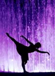 Silhouette of a dancer against a purple background.
